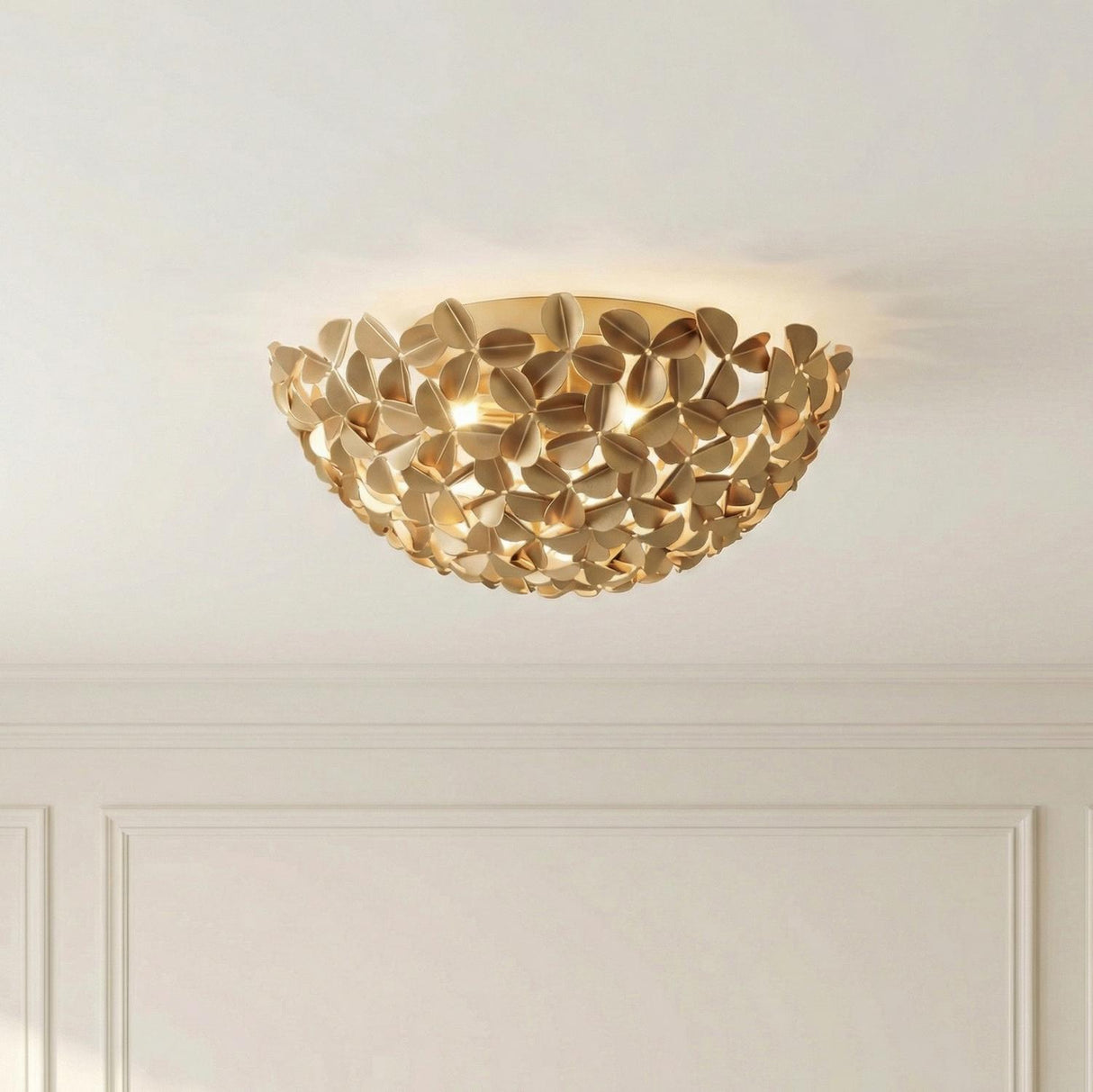 Florence Flush Mount 16", Soft Brass leaf design Flush Mount in a Transitional Living Room with white wall molding.
