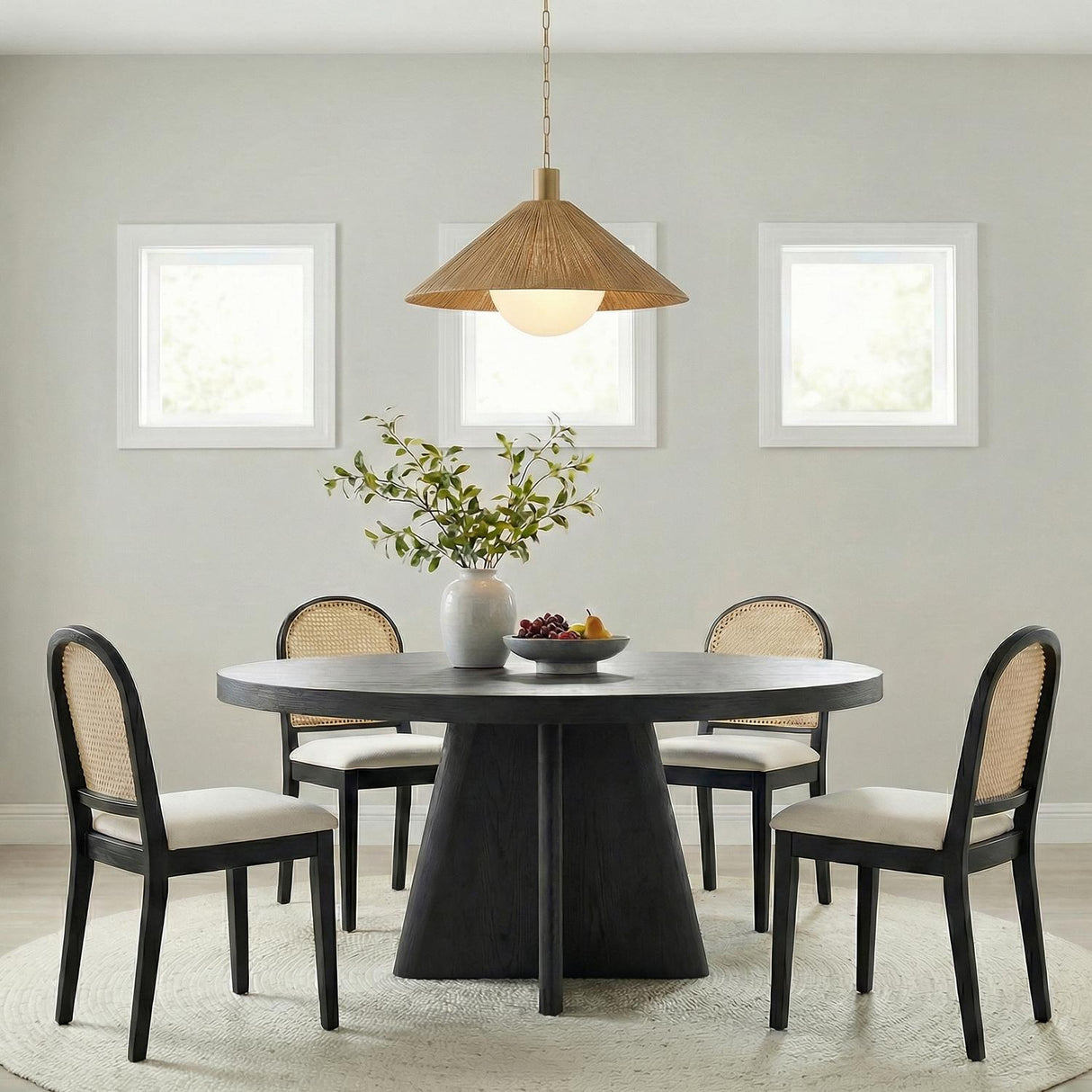 Fawn Large Pendant 32", Patina Brass and Rattan with Opal Glass woven pendant in a Contemporary Dining Room with a round black table.