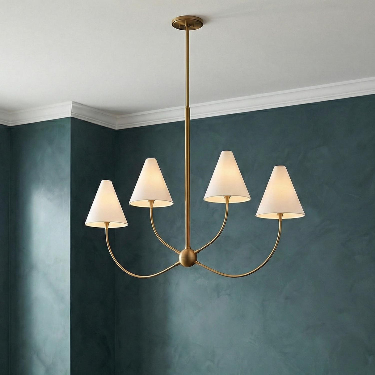 Yara 4 Light Chandelier, Patina Brass geometric Chandelier in a Transitional Dining Room with textured teal walls.