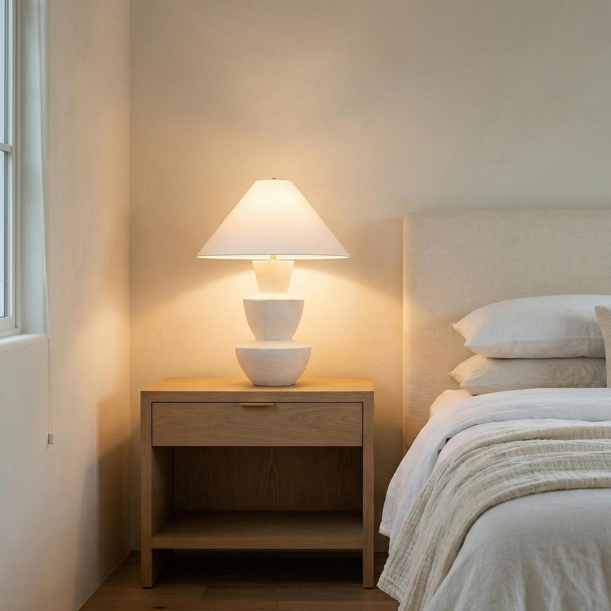 Andrea Table Lamp 27", Whitewashed Ceramic geometric Table Lamp in a Modern Bedroom with an oak nightstand and white bedding.
