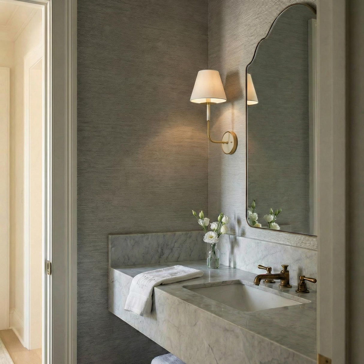 Cicero Wall Sconce 17", Off White and Aged Brass linear Wall Sconce in a Transitional Bathroom with a white marble vanity.