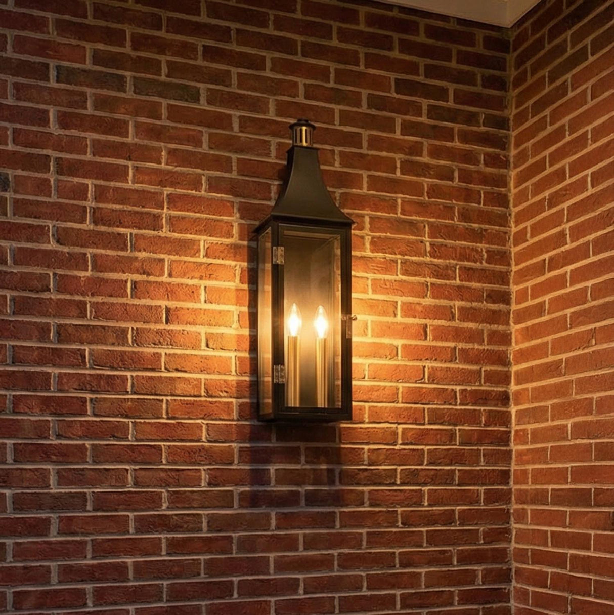 Dante Outdoor Wall Light, Large 24", Black and Brass geometric Outdoor Wall in a Traditional Outdoor space with a red brick wall.