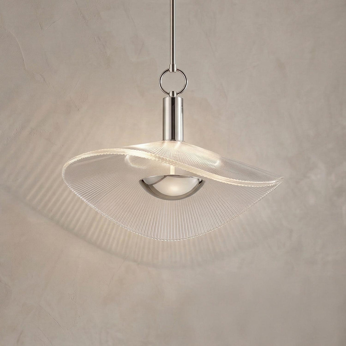 Celine Medium LED Pendant 18", Polished Nickel and Clear Ribbed Glass scalloped Pendant in a Contemporary Entryway with a textured wall.