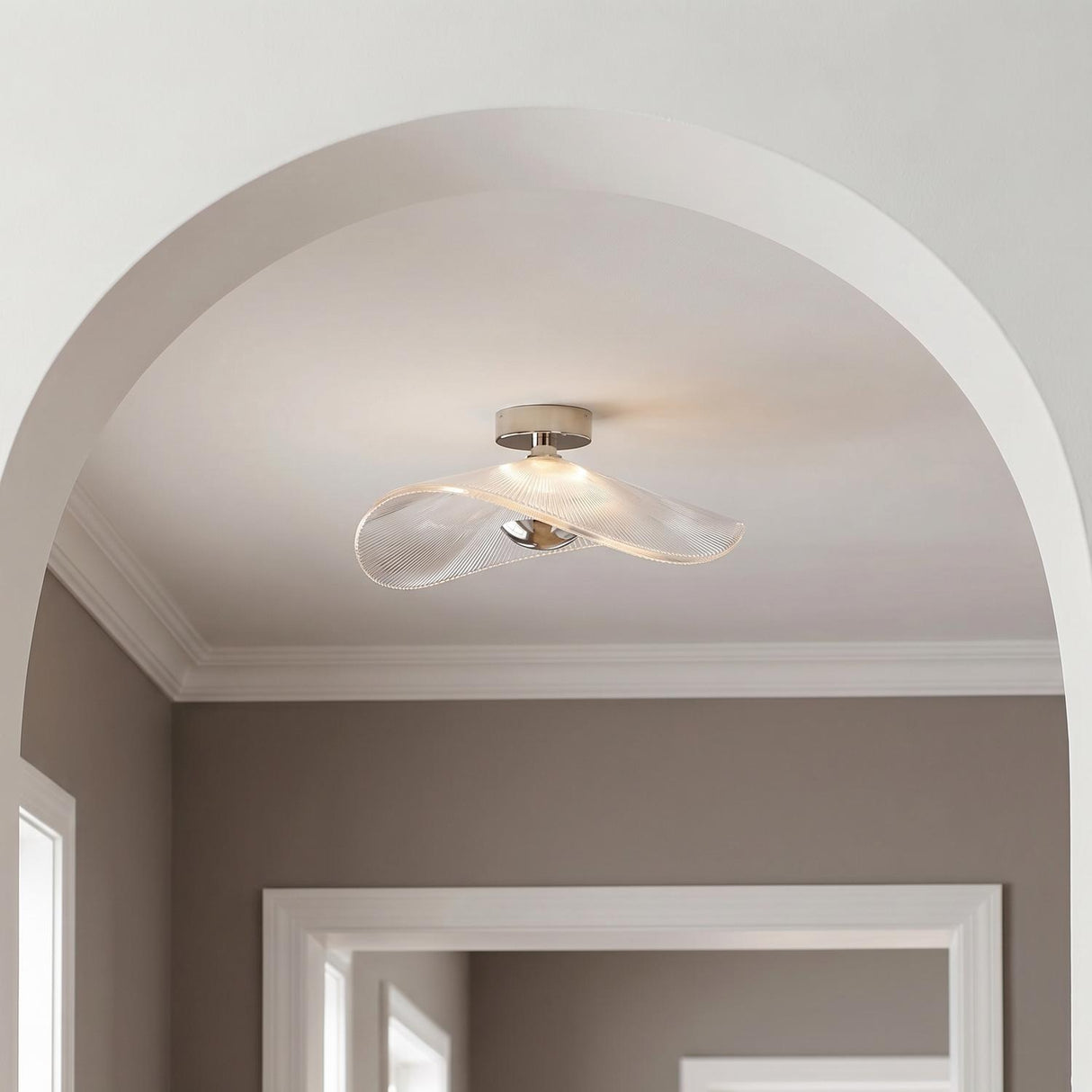 Celine Large LED Semi-Flush 24", Polished Nickel and Clear Ribbed Glass scalloped semi-flush in a Transitional Hallway with arched entry.