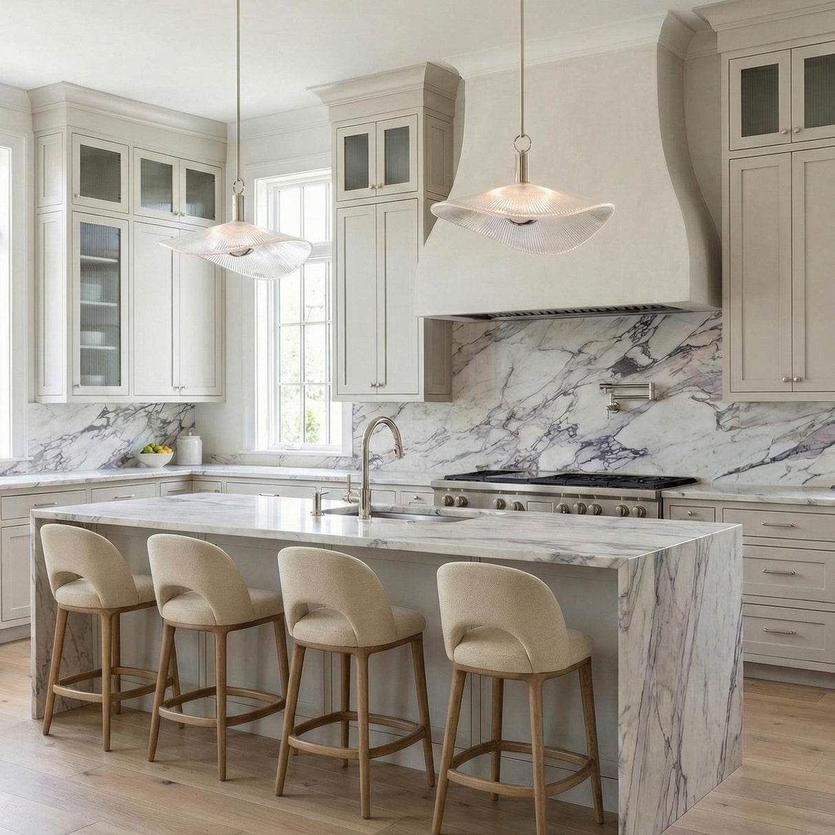 Celine Large LED Pendant 24", Polished Nickel and Clear Ribbed Glass scalloped Pendant in a Transitional Kitchen with a marble waterfall island.