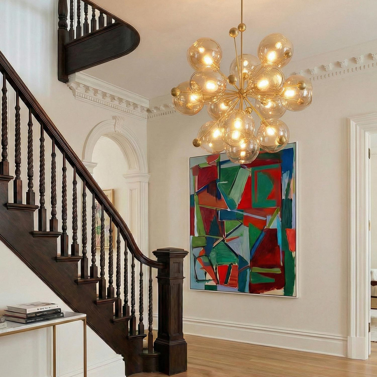 Bianca Extra Large Chandelier 46", Patina Brass and Topaz Glass globe Chandelier in a Traditional Entryway with a dark wood staircase.