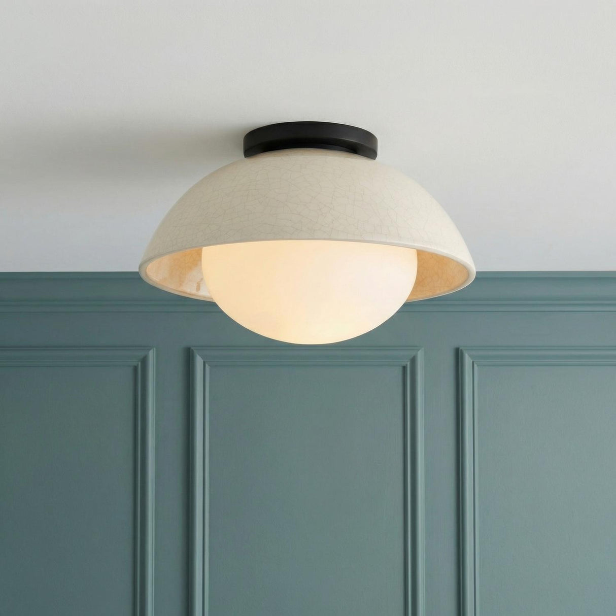 Hanley Flush Mount 12", Black and Ivory Crackle Ceramic globe Flush Mount in a Transitional Entryway with teal wood wall paneling.