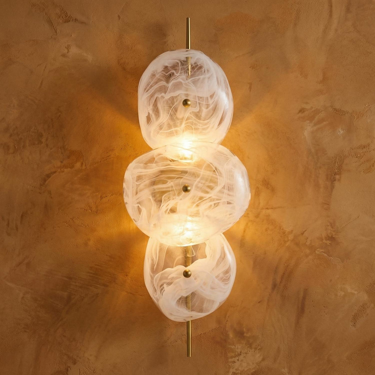 Malina Wall Sconce 30", Antique Brass and Art Glass globe Wall Sconce in a Contemporary Entryway with a textured plaster wall.