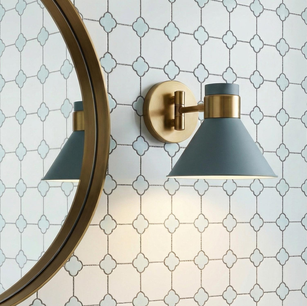 Cosette Adjustable Wall Sconce 8", Fog Blue and Antique Brass geometric wall sconce in a Contemporary Bathroom with a round brass mirror.