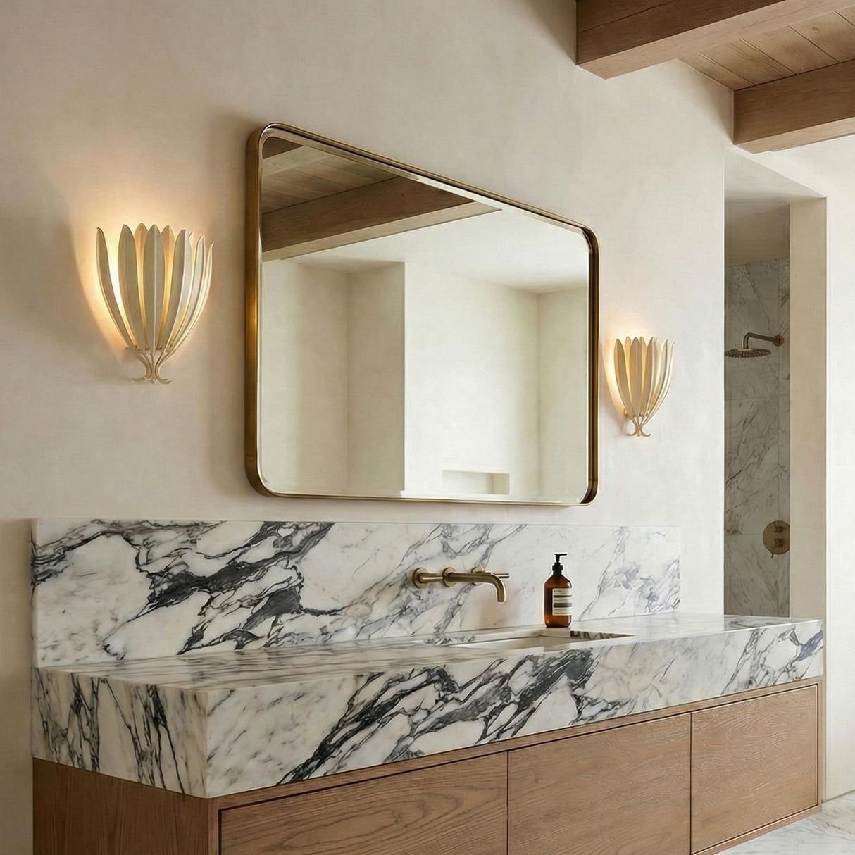 Yasmin Wall Sconce 13", Cream leaf design Wall Sconce in a Contemporary Bathroom with a marble vanity and brass mirror.