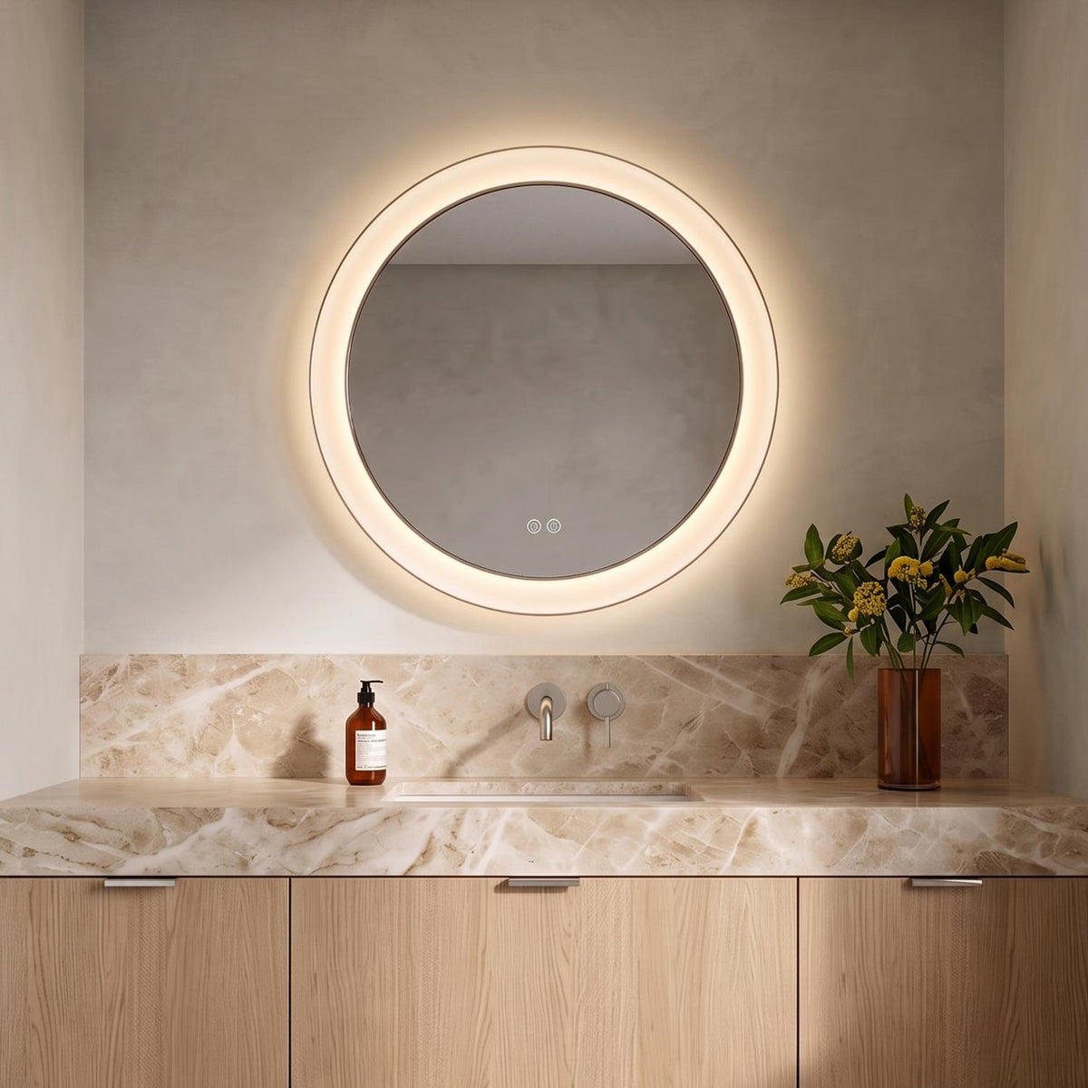 A modern bathroom with the Hedley Round LED Mirror 24" x 24", Polished Nickel mounted above a tan marble countertop and light oak vanity cabinets.