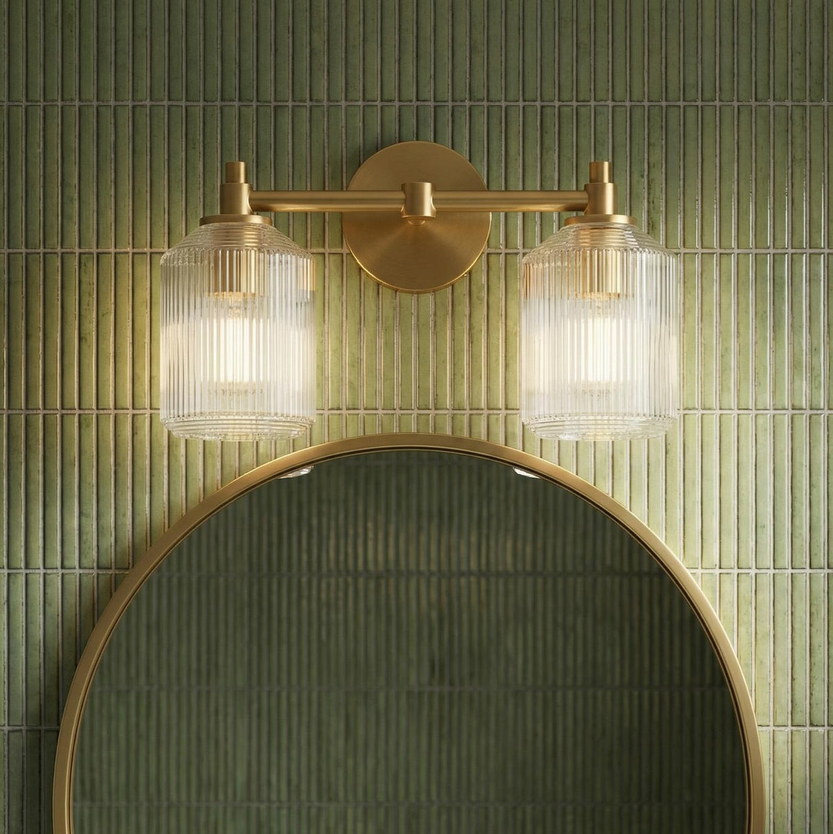 Lathan 2 Light Vanity 15", Modern Brass linear vanity in a Modern Bathroom with green vertical tile and a round gold mirror.