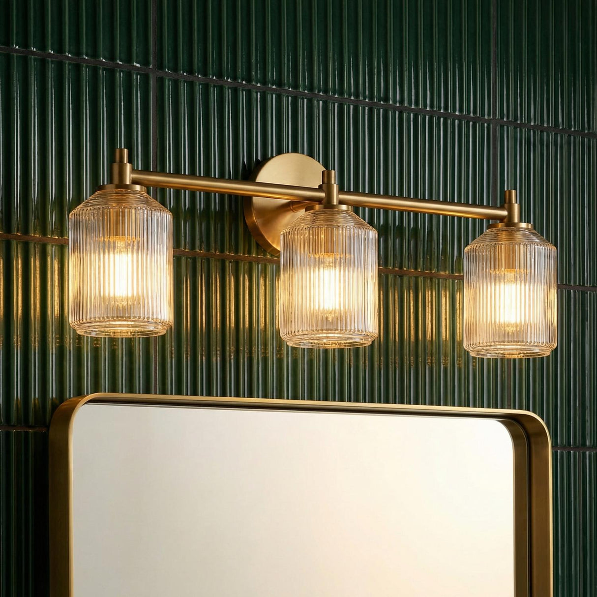 Lathan 3 Light Vanity 26", Modern Brass linear vanity in a Contemporary Bathroom with green fluted tile and a gold mirror.