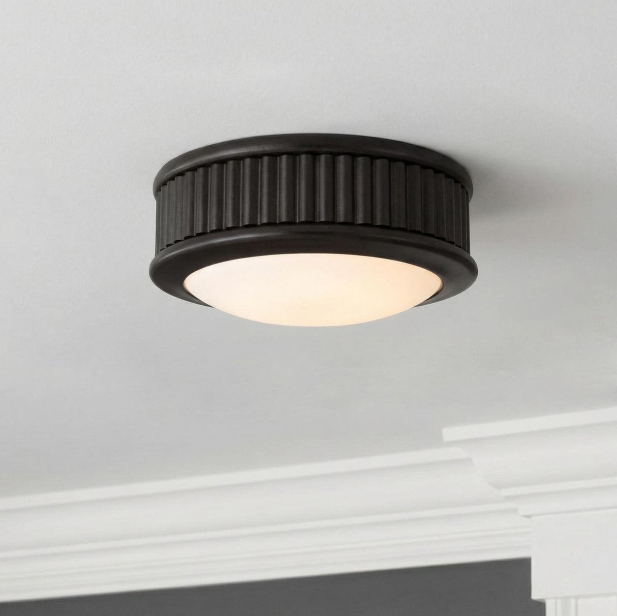 Bishop Extra Small LED Flush Mount 5", Aged Iron geometric flush mount in a Transitional Hallway with white crown molding.