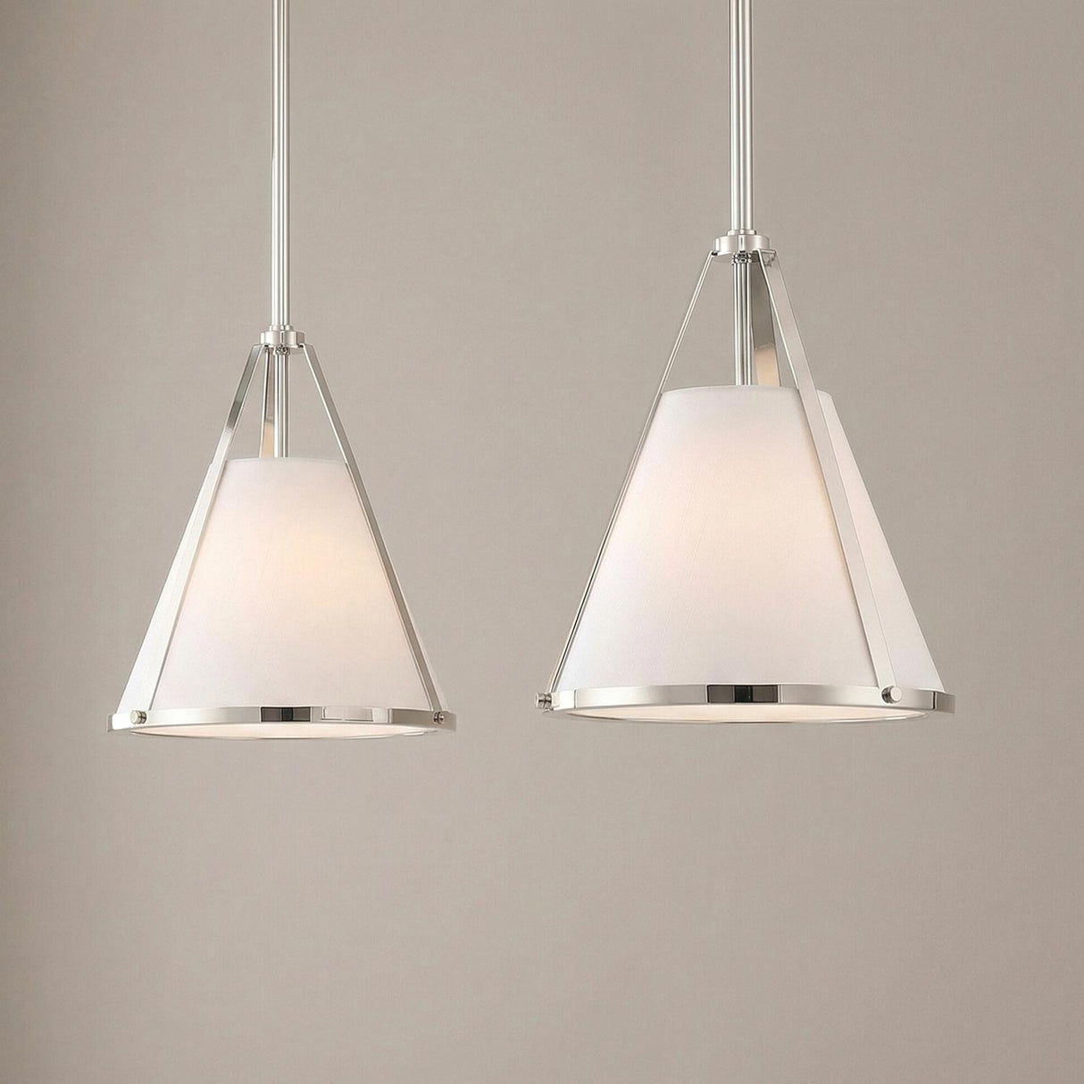 A transitional kitchen scene showcases two Hoyt Small Conical Pendant 9", Polished Nickel fixtures with white linen shades and polished nickel hardware positioned over the island.
