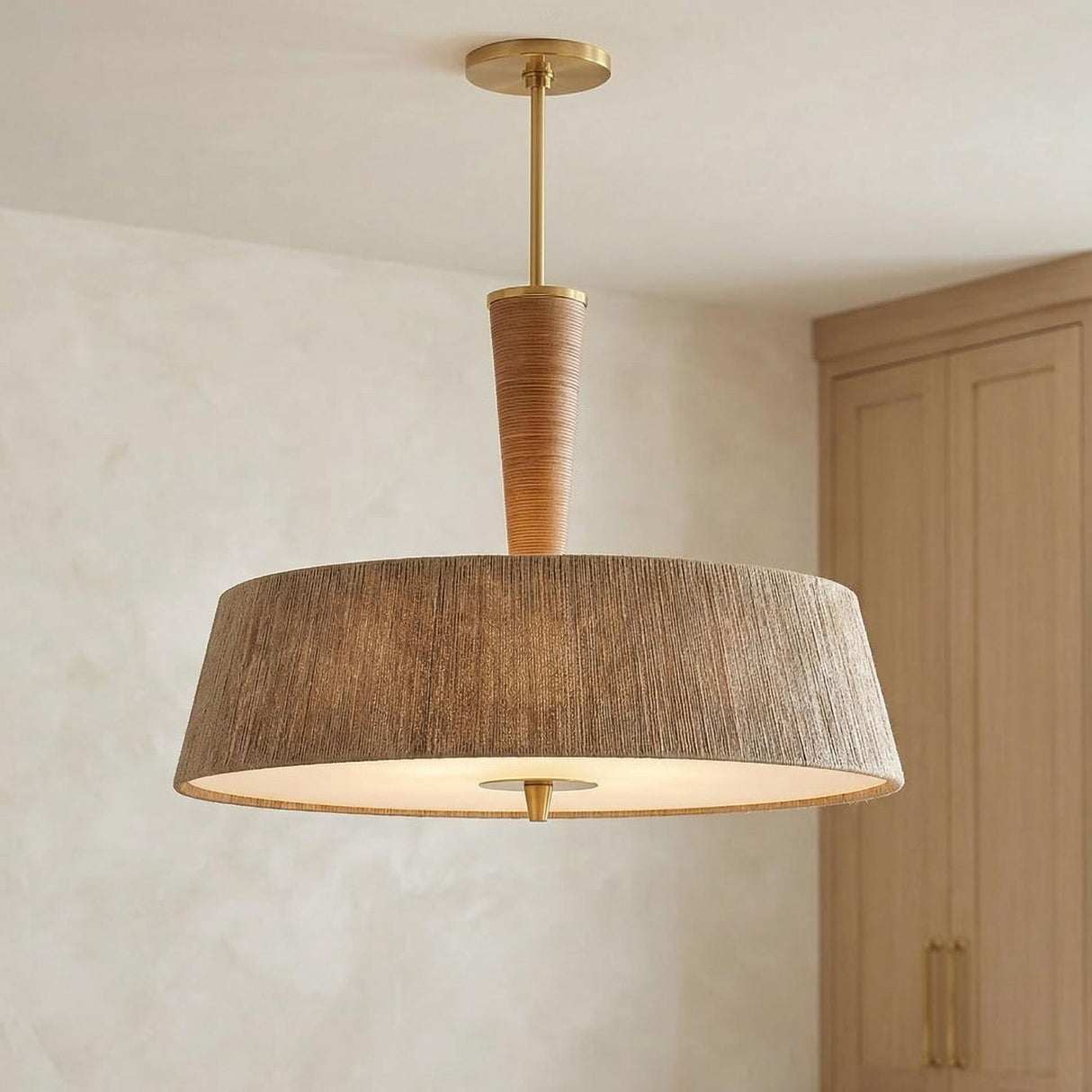 Pascal Extra Large Pendant 30", Jute, Rattan and Aged Brass woven Pendant in a Coastal Dining Room with light oak cabinets.