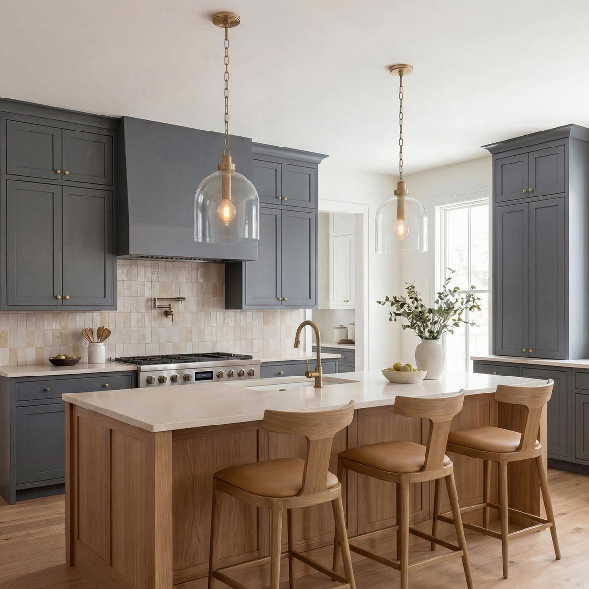 Brass glass globe pendant in a Modern Farmhouse Kitchen with a wooden island and gray cabinets.