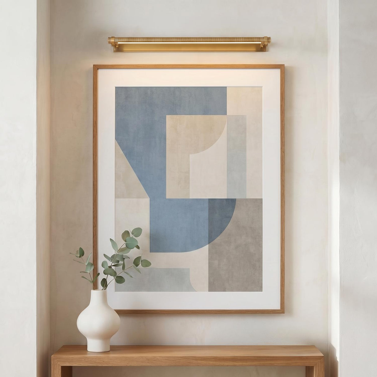 Heath LED Picture Light 30", Aged Brass linear picture light in a Contemporary Entryway with a wood console and abstract art.