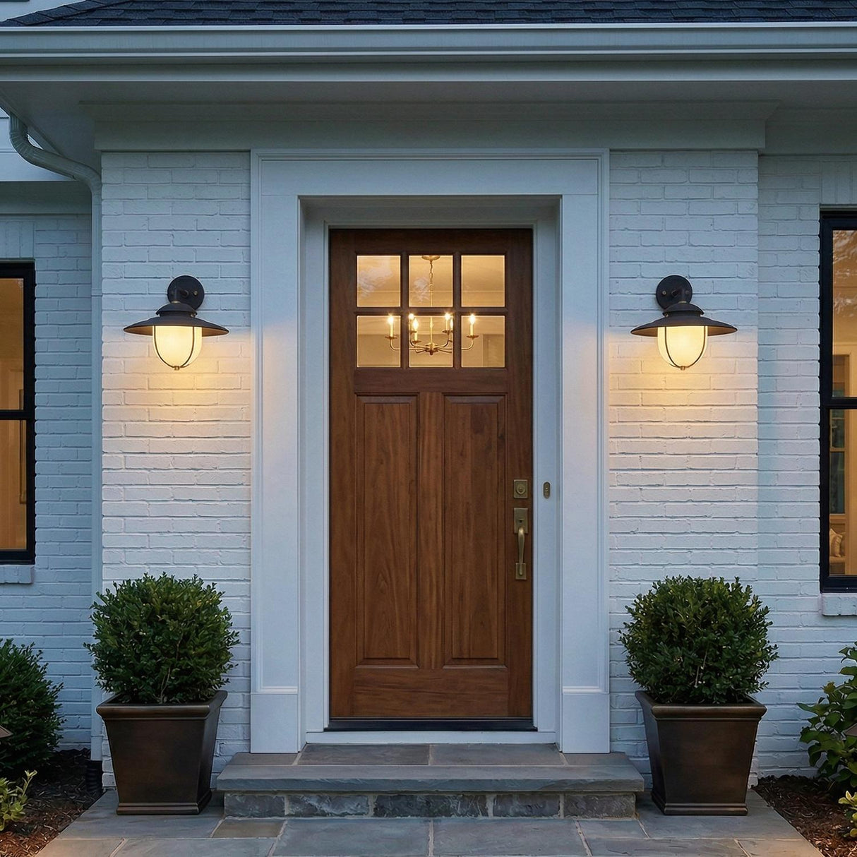 Oswego Outdoor Wall Light, Medium 13", Forged Iron globe Outdoor Wall in a Modern Farmhouse Outdoor with a wood door and boxwood planters.