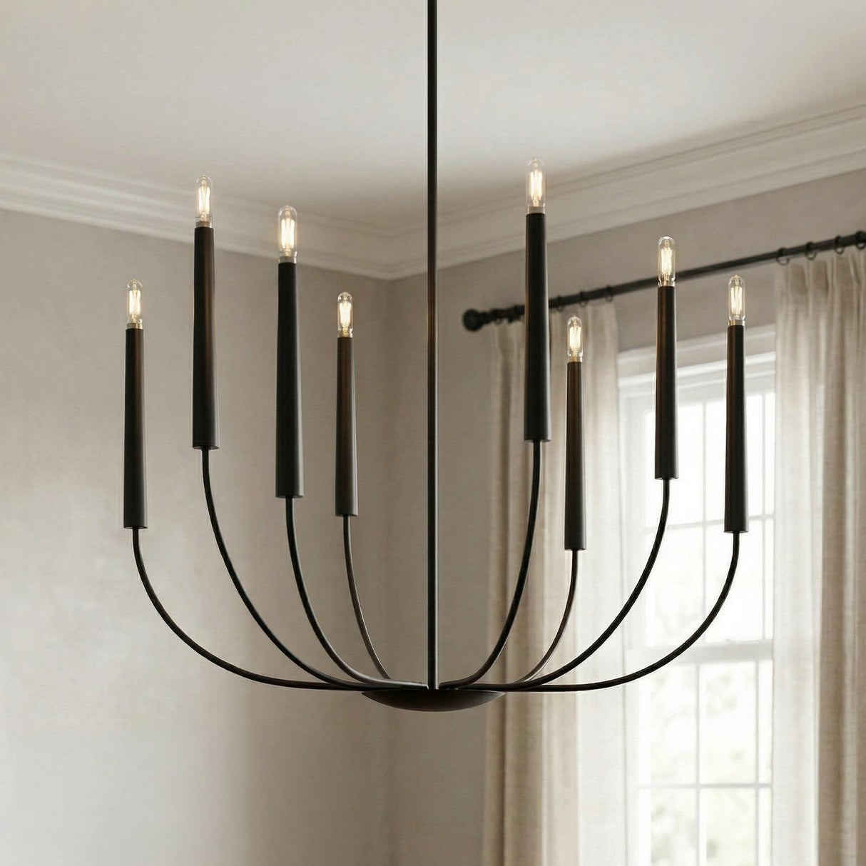 A transitional dining room featuring the Solana 8 Light Chandelier in an aged iron finish suspended from the ceiling center near a window with beige linen curtains.