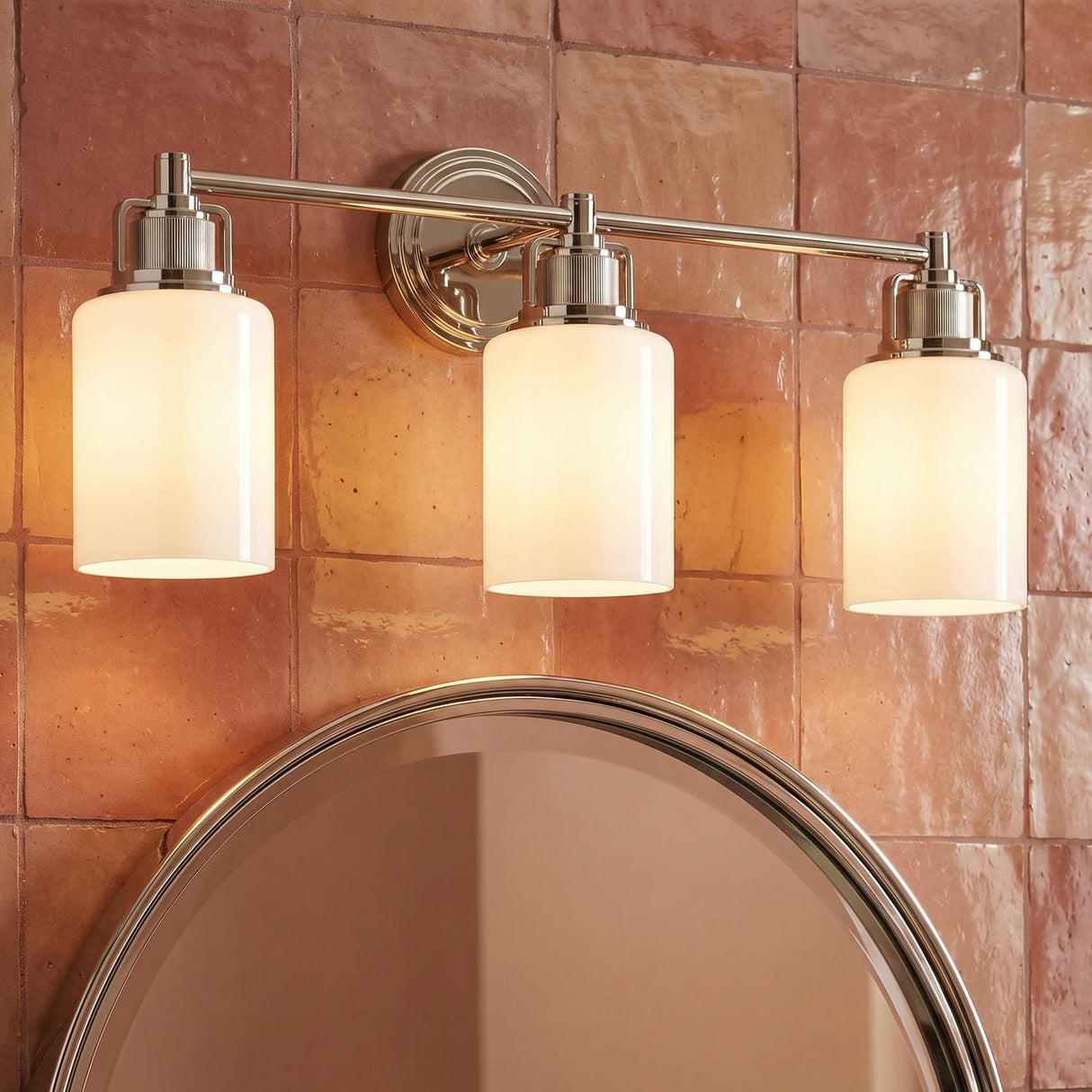 Claxton 3 Light Vanity, Polished Nickel geometric vanity in a Transitional Bathroom with terracotta tile and a round mirror.