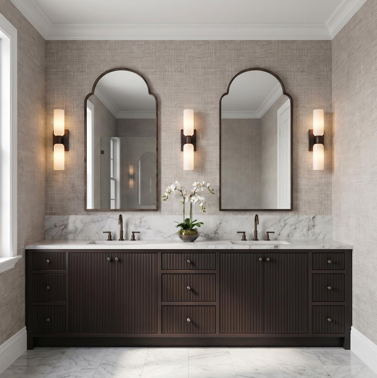 Vesper 2 Light Vanity 21", Aged Iron linear vanity in a Transitional Bathroom with a white marble double vanity and arched mirrors.