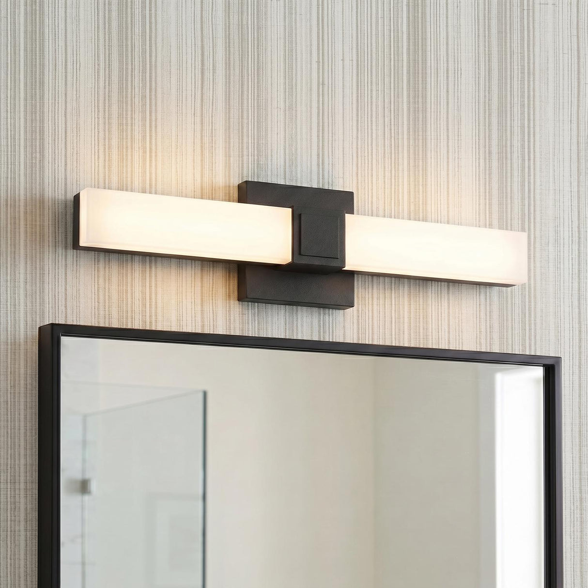 A contemporary bathroom featuring a matte black and frosted acrylic vanity bar installed above a matching black-framed mirror against gray textured wallpaper.