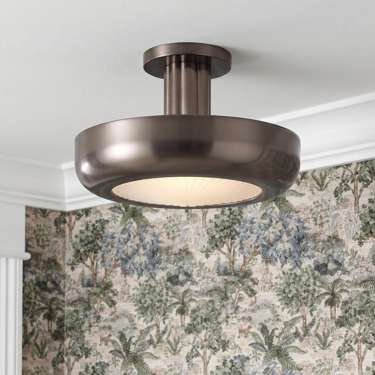 A traditional foyer with the Imara Medium LED Semi-Flush 16 in pewter bronze and ribbed glass mounted to a ceiling with white crown molding and landscape wallpaper.