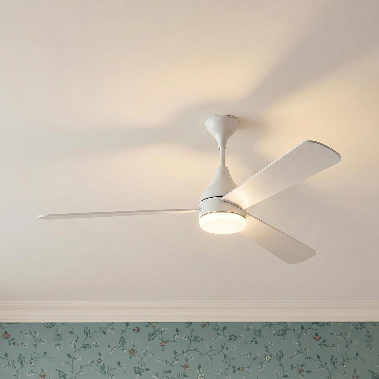 A traditional bedroom featuring the Serin LED Ceiling Fan 60", Matte White with a frosted glass light kit mounted to the ceiling center above floral wallpaper.