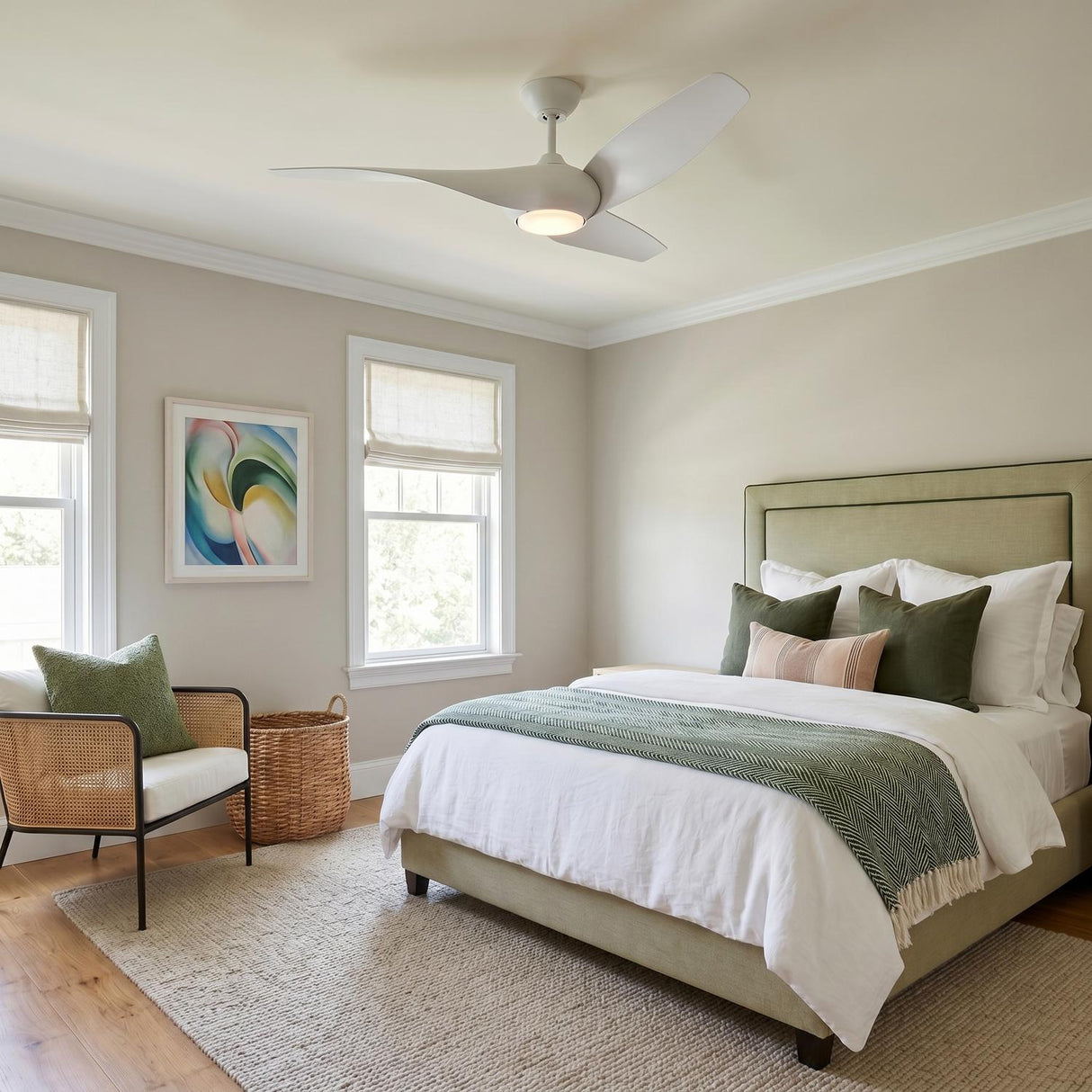 A contemporary bedroom with a matte white Krestel LED Ceiling Fan 52" mounted in the ceiling center above a sage green upholstered bed and woven rattan chair.