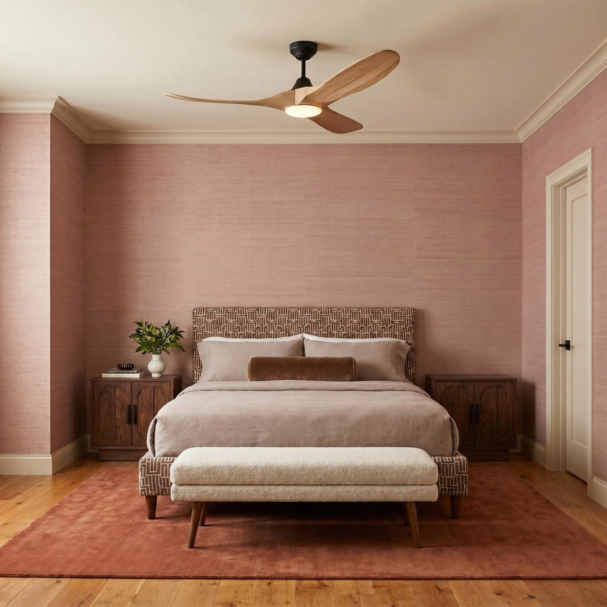 A mid-century bedroom featuring the Egret LED Ceiling Fan 52", Natural Oak and Matte Black at the ceiling center above a patterned headboard and mauve grasscloth walls.