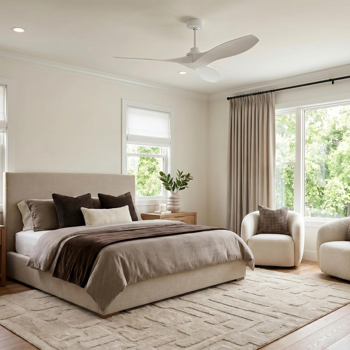 Egret ceiling fan in white is rated for indoor or outdoor use and is shown in a modern bedroom with luxe upholstered furniture and cream walls.