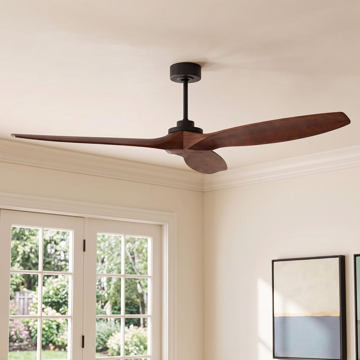 A contemporary living room with the Heron Smart Ceiling Fan 70", Walnut Wood and Matte Black along the ceiling center near a French door and abstract art.