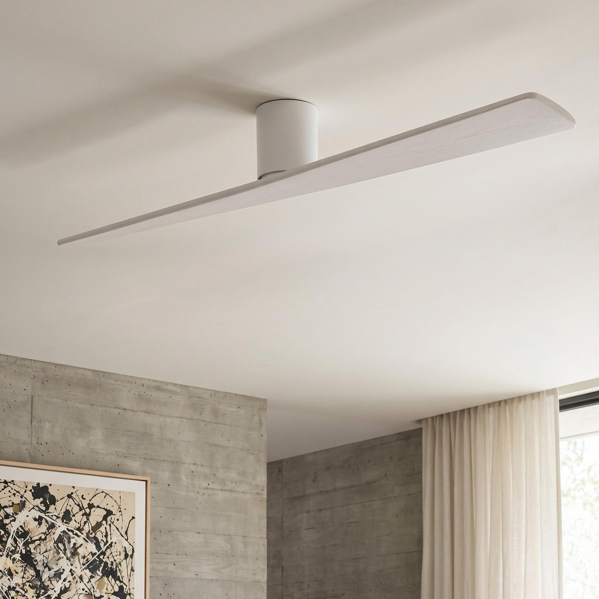 A minimalist living room with the Finch Smart Ceiling Fan 72" in Matte White Oak along the ceiling center beside concrete walls and neutral curtains.