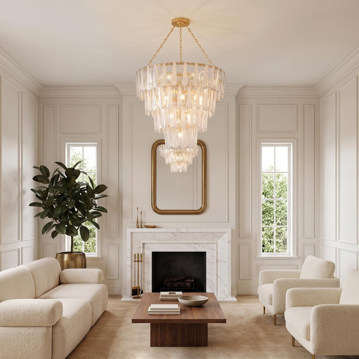 A transitional living room featuring a gold leaf and piastra glass chandelier suspended over a marble fireplace, walnut coffee table, and cream boucle furniture.