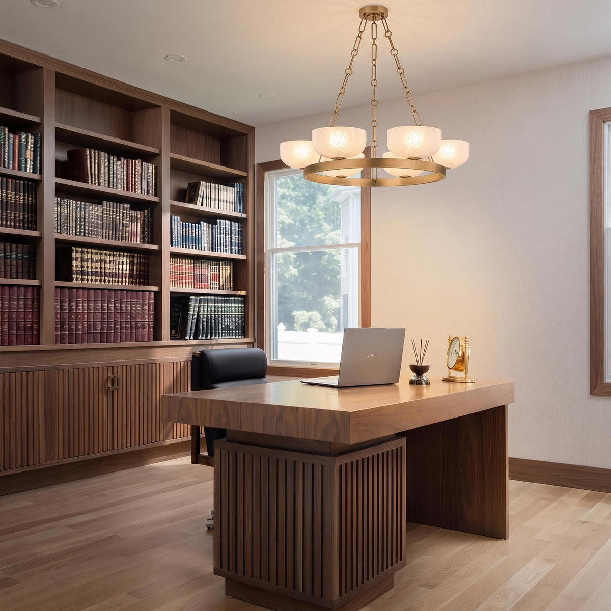 A transitional office features the Halcyon 6 Light Chandelier 32 inch, Patina Brass and Seeded Cloud Glass suspended above a wooden desk and built-in bookcases.