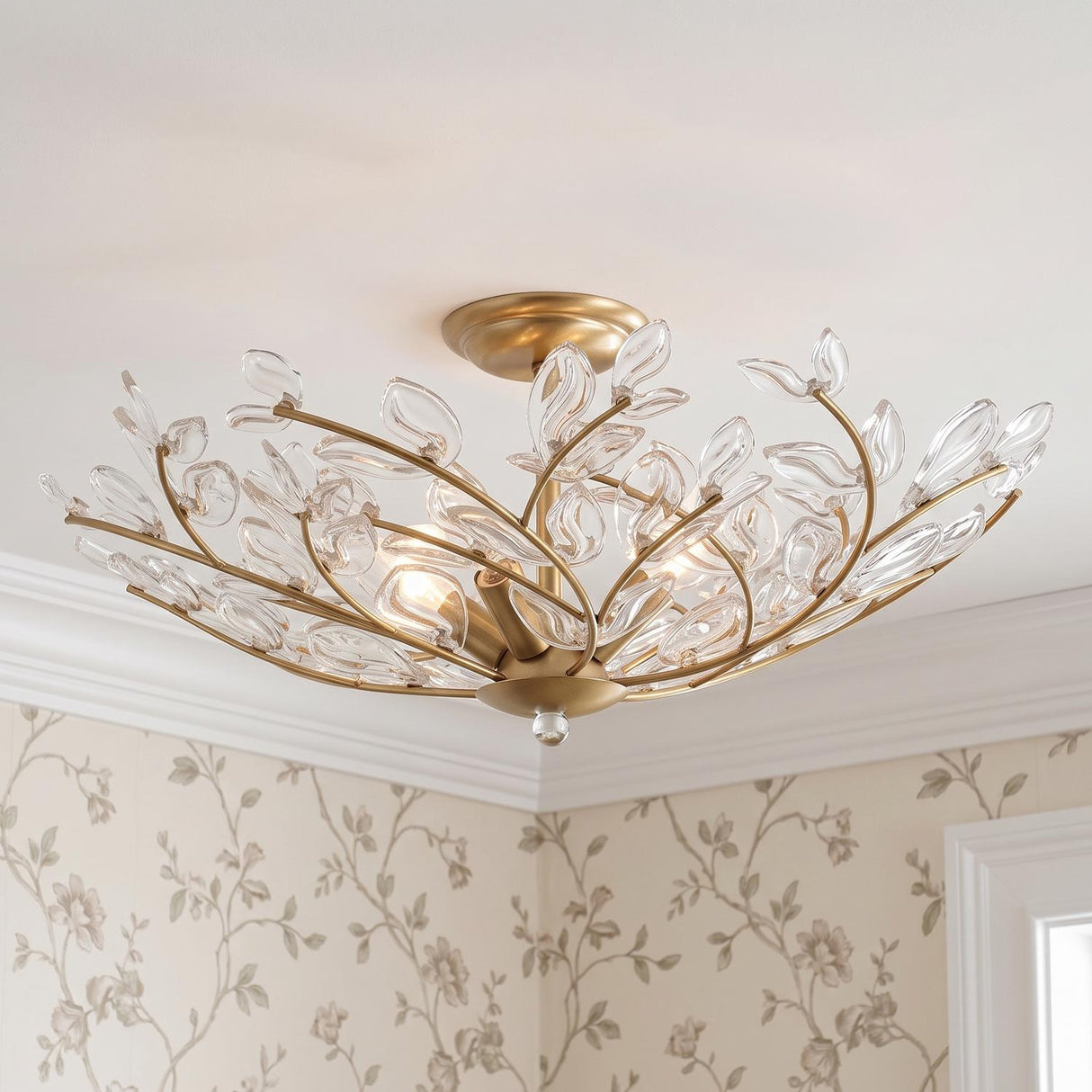 A traditional bedroom featuring the Esme Semi-Flush 22 inch soft brass and clear glass leaf fixture along the ceiling above floral wallpaper and white crown molding.