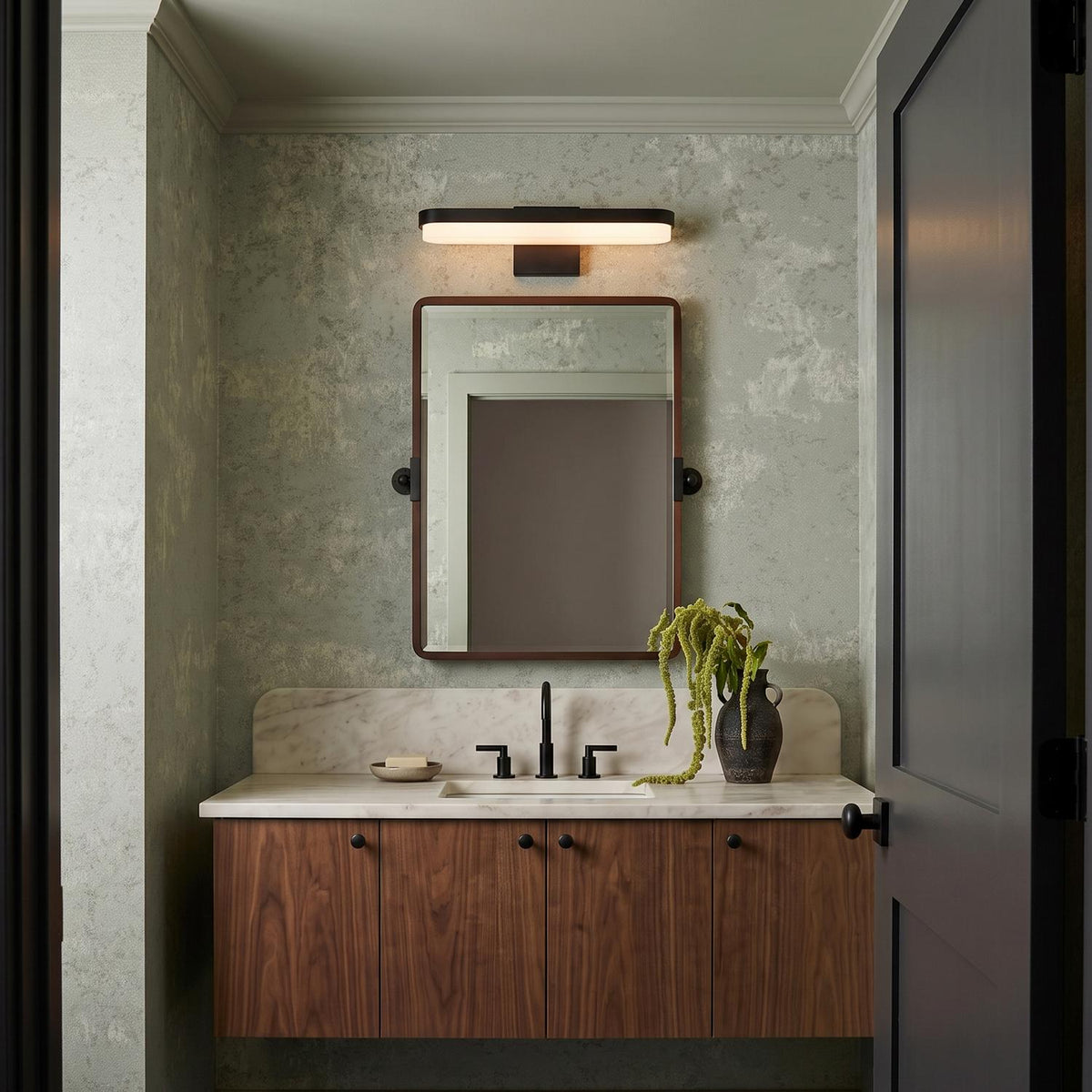 A contemporary bathroom featuring the Harbor LED Vanity Light 18", Matte Black over a rectangular mirror above a white marble countertop and floating walnut vanity.