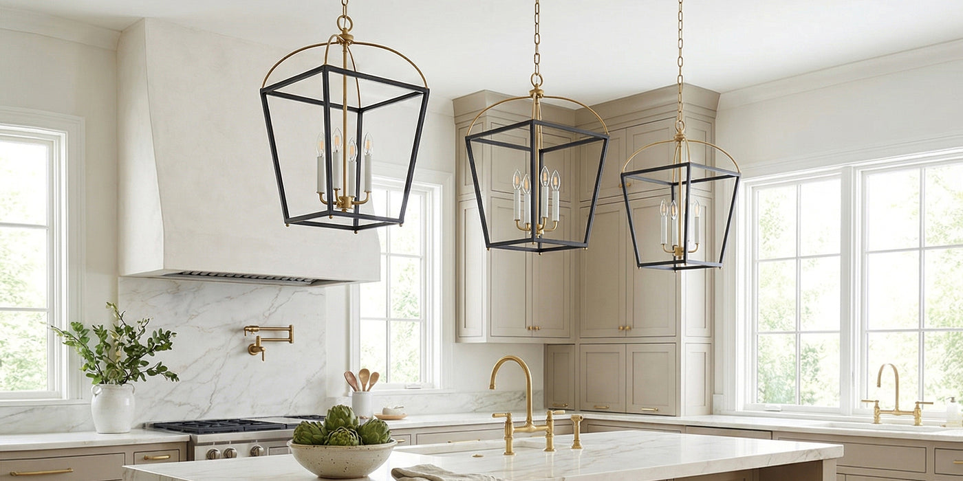 Three Langford Large Lantern Pendant hanging lights in Black and Satin Brass in a large transitional kitchen with taupe custom cabinetry and marble slab counters.