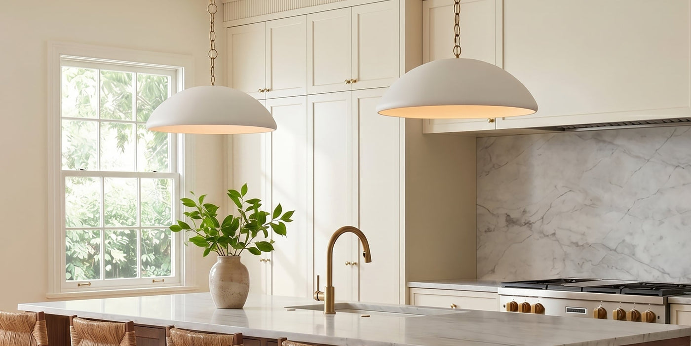 Two Charlie Pendants 28" wide, in Matte White and Brushed Brass chains hung in a bright transitional kitchen with large island.