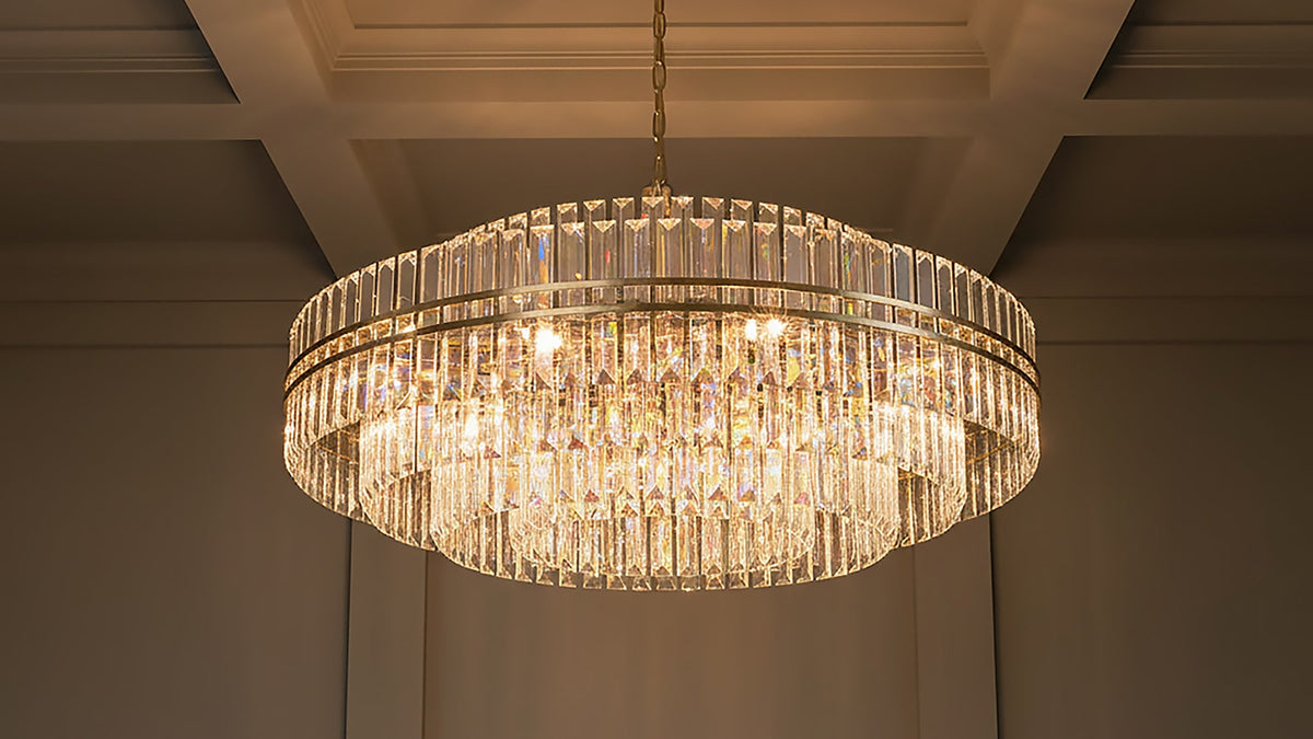 Shop crystal and glass chandeliers featuring sparkling crystal drops, faceted accents, and sculptural glass designs in styles from classic glamour to modern. Maxwell Chandelier shown in Brass & Crystal.