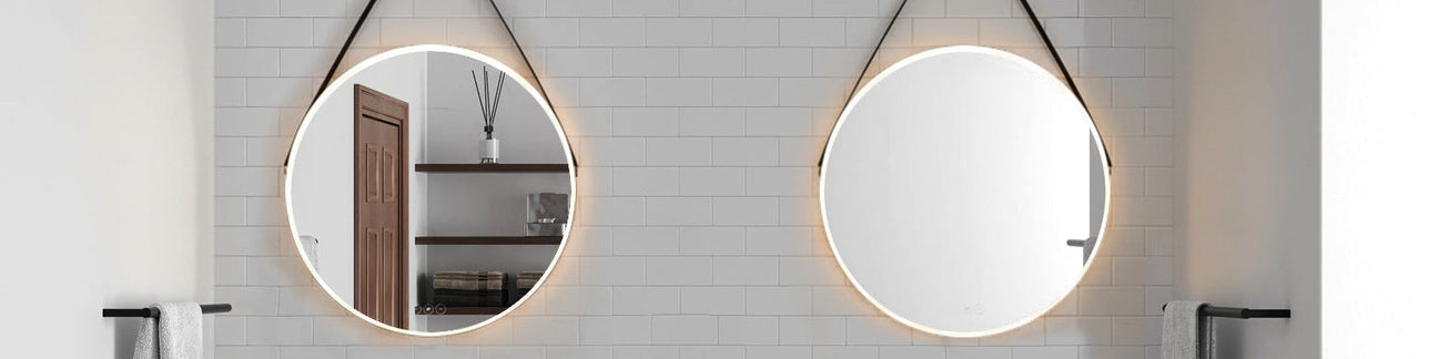 Two 24" round Merrison LED backlit Smart Mirrors are shown in a birght white bathroom with subway tile..
