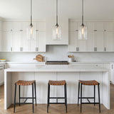 Windsor Heights Cylinder Glass Pendant 7" Black geometric pendant in a Transitional Kitchen with a white marble island.