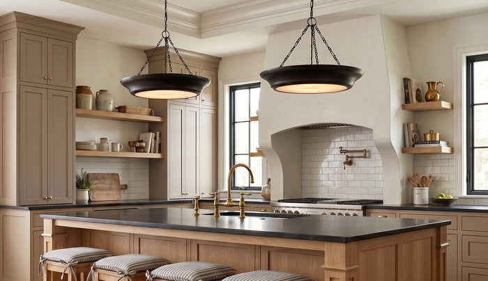Modern kitchen with wooden island, black countertops, and two Dalina Large Pendants in Aged Iron finish.