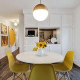 Powell 14" Pendant light in a dining room of a mid century modern home, with yellow chairs and modern art. Photo from Kit Williamson