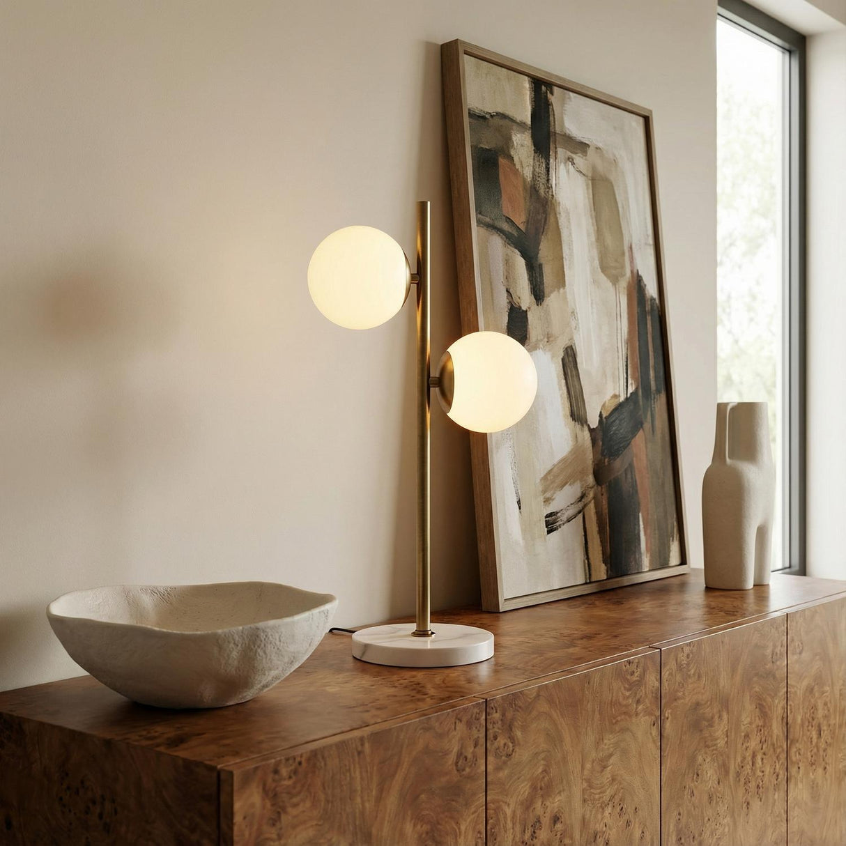 Castell 2 Globe Table Lamp, Aged Brass globe Table Lamp in a Modern Living Room with a burl wood credenza.