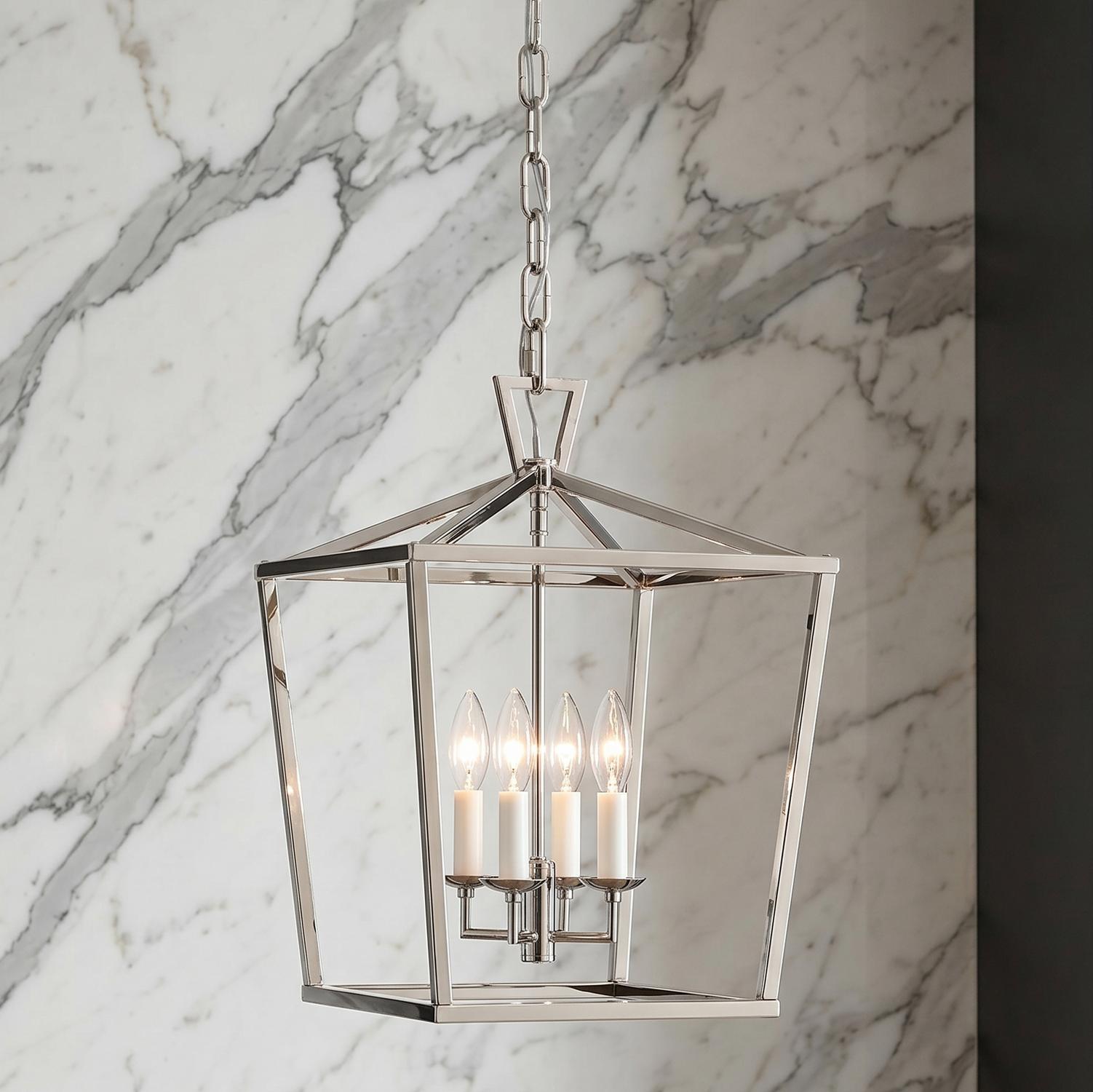 A transitional foyer with the Anover Medium Lantern Pendant in polished nickel hanging over the entry against a white marble wall with grey veining.
