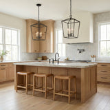 Anover Large Lantern Pendant 17", Matte Black geometric pendant in a Modern Farmhouse Kitchen with a white marble island and wood stools.