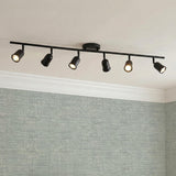 Bixby 44" 6-Light Fixed Track Light, Matte Black linear Fixed Track Light in a Modern Office with textured sage wallpaper.