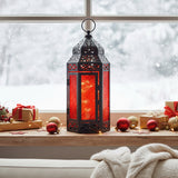 Red Glass Moroccan Christmas Lantern with twinkle lights for modern red and black holiday decor, shown in a winter window sill